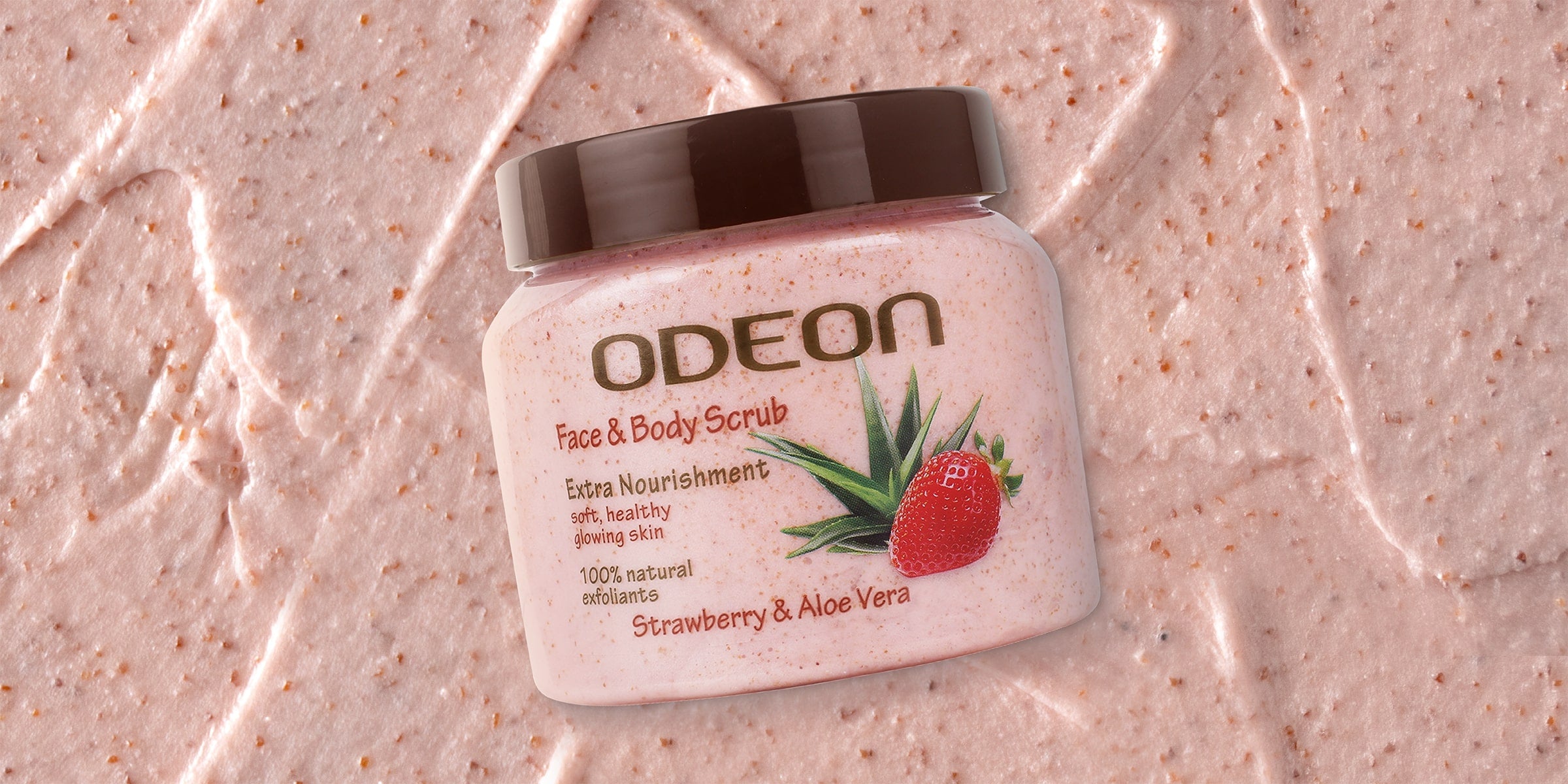 Odeon Face & Body Scrub with Strawberry & Aloe Vera, featuring 100% natural exfoliants for extra nourishment and glowing skin, placed on a textured scrub background